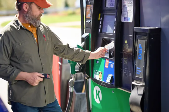 man tapping card to pay for fuel