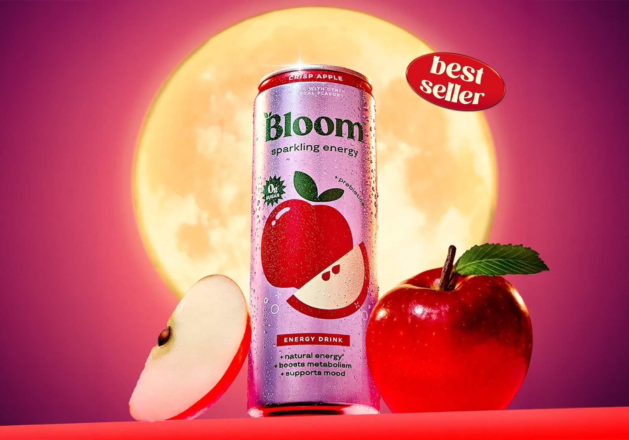 Bloom Sparkling Energy Crisp Apple can beside a sliced apple and a whole red apple in front of a glowing full moon