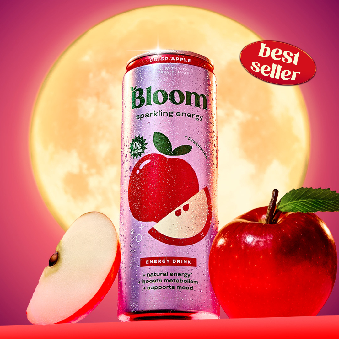 Bloom Sparkling Energy Crisp Apple can beside a sliced apple and a whole red apple in front of a glowing full moon