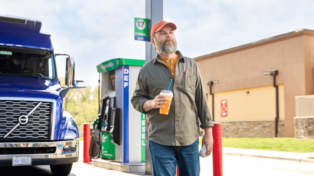 Man walking towards a Circle K station store after parking his truck to fuel