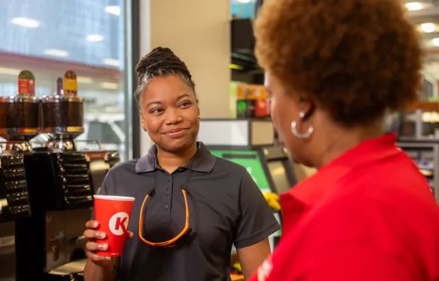 Business woman talking to a Circle K employee at a Circle K store