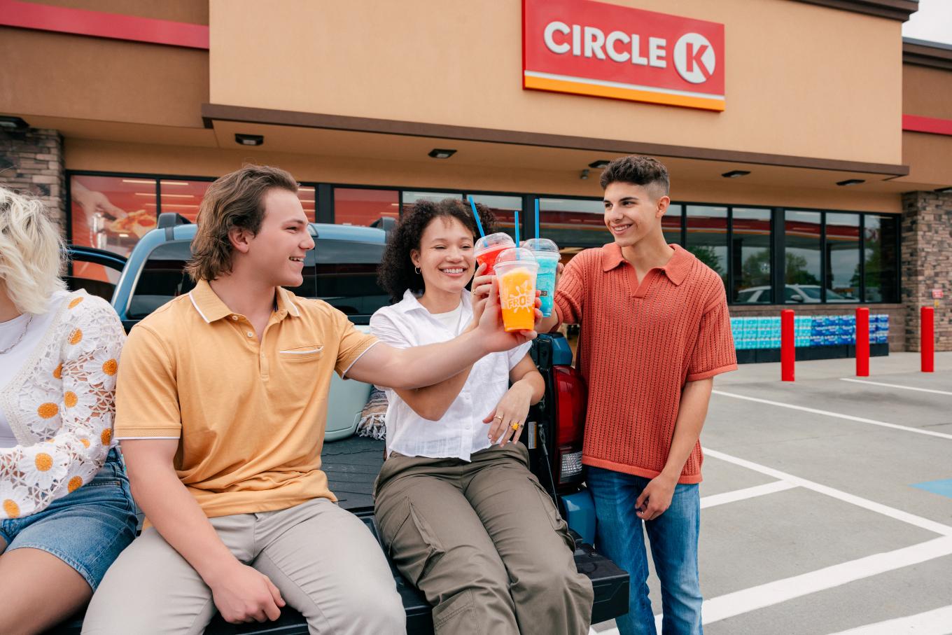 3 people outside of Circle K drinking Frosters