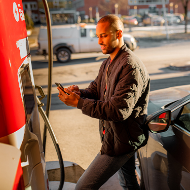 A man charges his electric vehicle at Circle K.