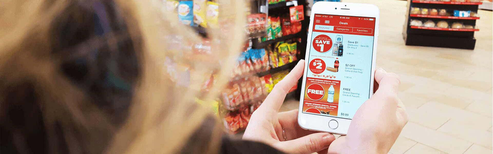 A woman uses the Circle K mobile app while shopping in-store.