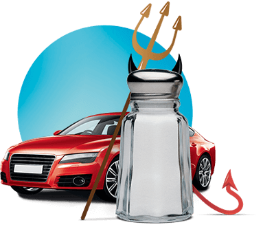 A salt shaker with devil's fork and tail, placed in front of a red car.